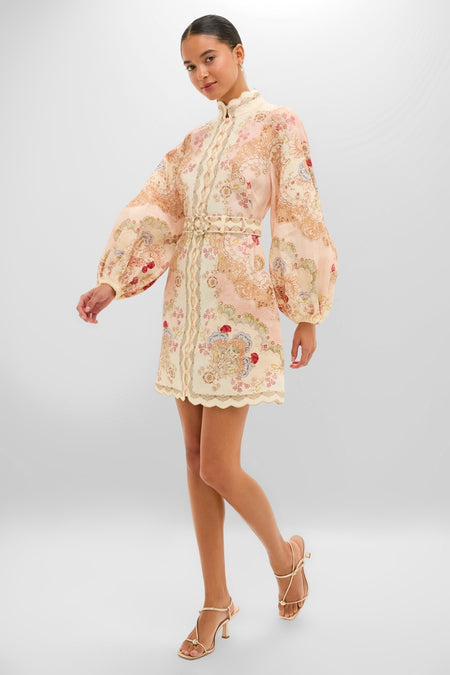 Young woman models the Wallpaper Floral Blush Daylight Mini Dress—a classic, high-end linen piece with floral embroidery, scalloped details, and bishop sleeves, embodying effortless elegance.