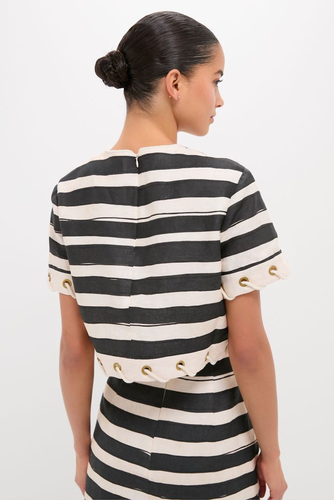 Woman wearing the Black Stripe Story Top, a classic, high-end crop with grommet and rope details, paired with a matching skirt for an effortless, fun look.