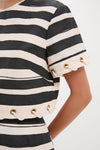 Close-up of the Black Stripe Story Top, featuring classic wide stripes and nautical grommet details. Effortlessly chic and fun, perfect for a high-end, confident look.