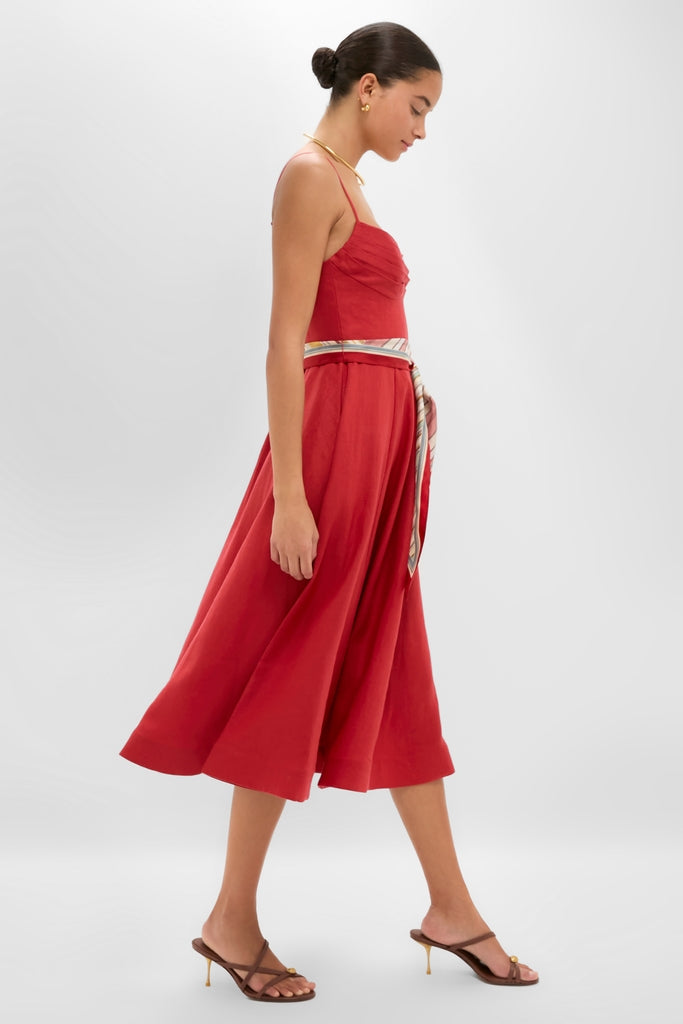 Classic Red Rebellion Tuck Midi Dress showcased effortlessly by a model, featuring adjustable spaghetti straps, pleated bodice, and a fun sash belt, epitomizing high-end sophistication.