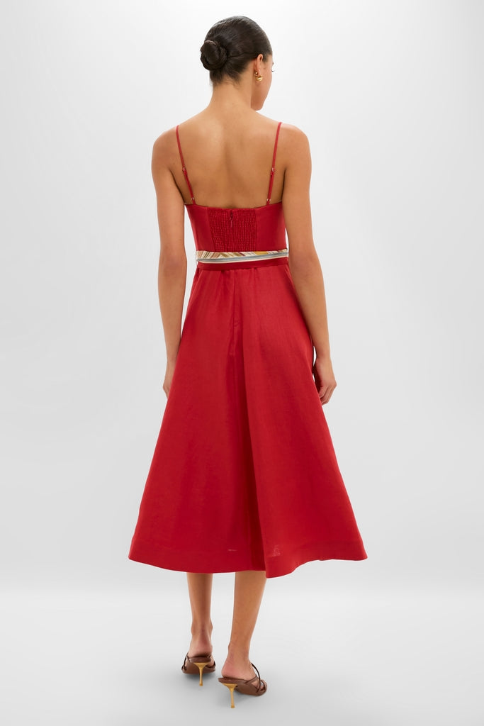Woman in a classic Red Rebellion Tuck Midi Dress with an empire waistline and flared skirt, embodying effortless, high-end style.