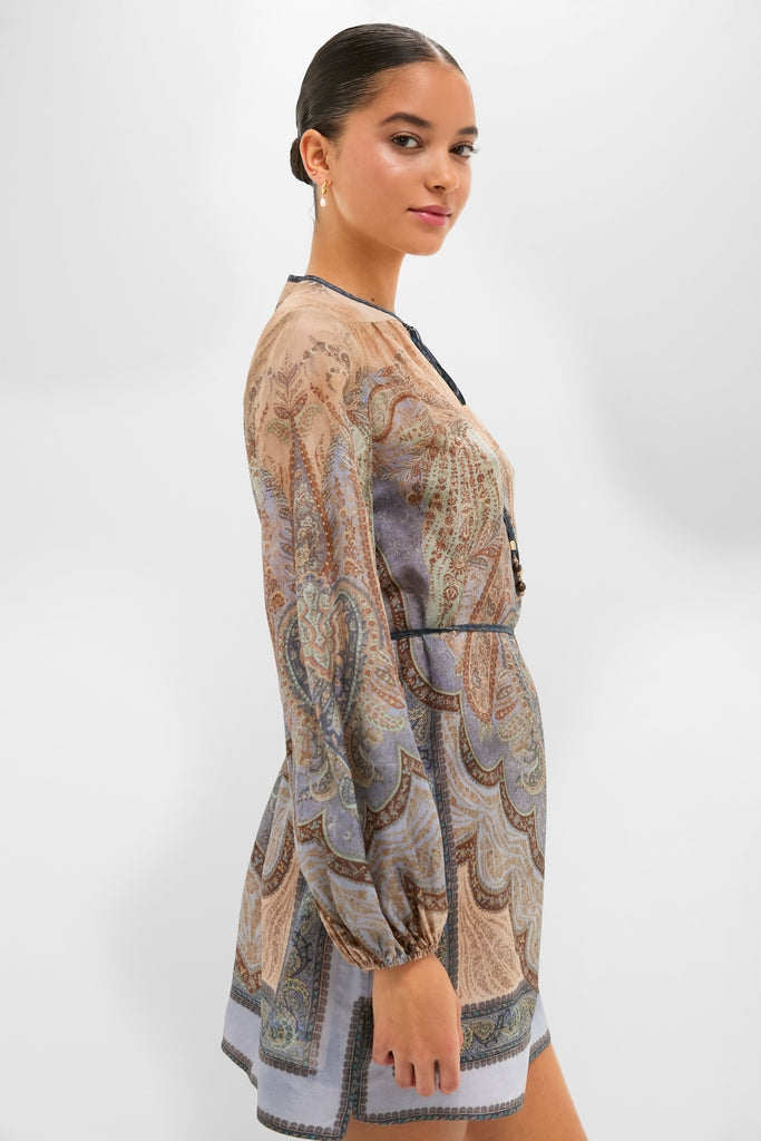 Woman in profile wearing the Tapestry Blue Multi Wanderlust Tunic with paisley print, showcasing its classic, effortless silhouette, long sleeves, and removable belt, capturing high-end, fun style.