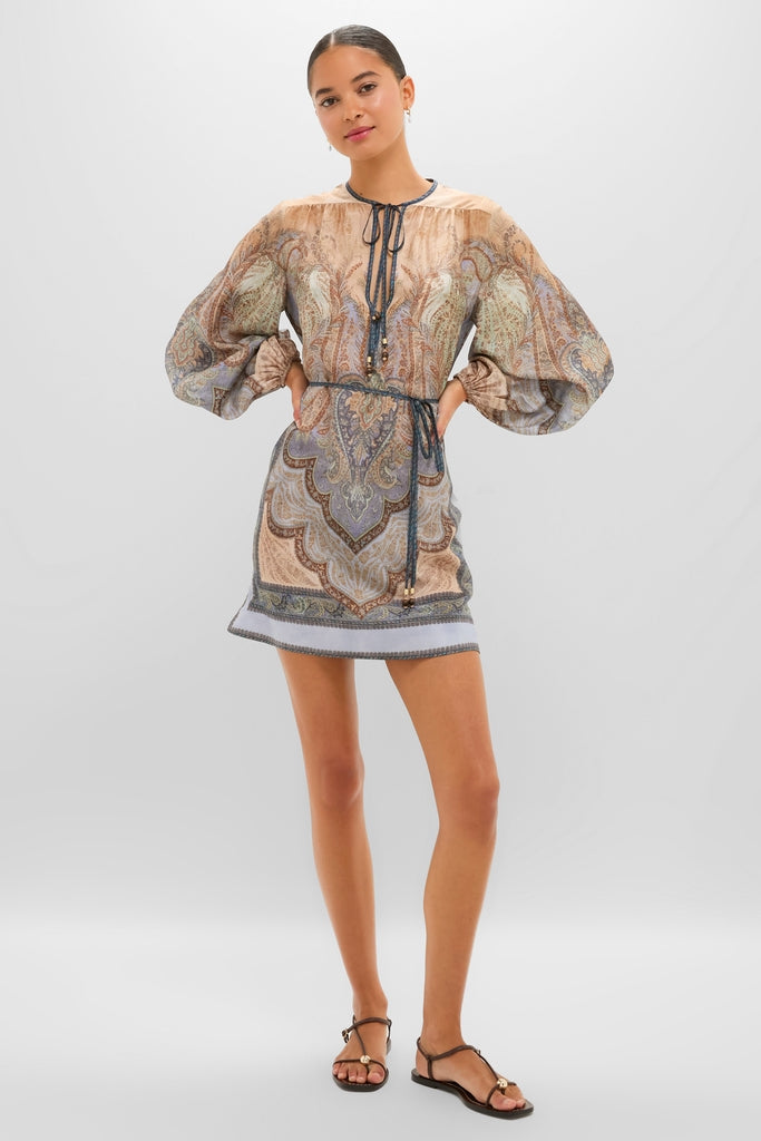 Model wearing the classic Tapestry Blue Multi Wanderlust Tunic with a fun paisley print, featuring an effortless split neckline, billowy sleeves, and a high-end braided belt.