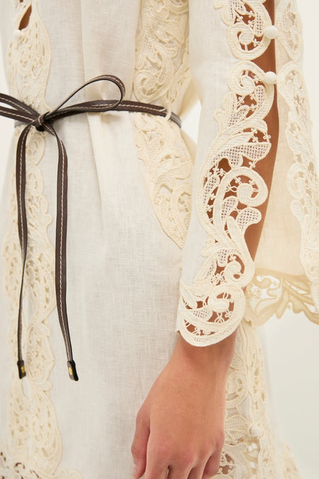 Cream Awaken Embroidered Tunic, a classic linen dress with openwork lace inserts, cinched by a leather belt, exudes effortless, high-end style. Perfect for fun, versatile looks.