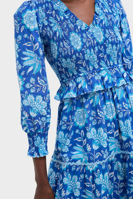 Ink Jaal Mia Dress features a classic, effortless blue floral-print with a smocked bodice, peplum ruffle, and tiered skirt, embodying fun, high-end style.