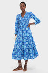 Model in an Ink Jaal Mia Dress, a classic, high-end floral midi with an effortless V-neck, puffed sleeves, smocked waist, and fun, tiered skirt.