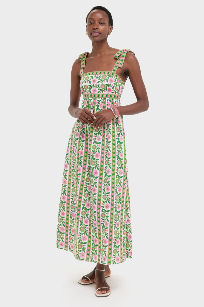 Emerald Border Mykonos Dress: A classic, sleeveless summer dress with a floral motif, featuring effortless shoulder-tie bows and a full skirt, embodying high-end, fun style.