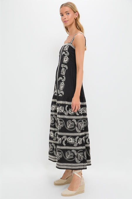 Sweetheart Rio Dress on model, showcasing an ankle-length, classic black sundress with effortless paisley embroidery. Styled with fun, high-end espadrille wedges, embodying Tuckernuck's cool confidence.