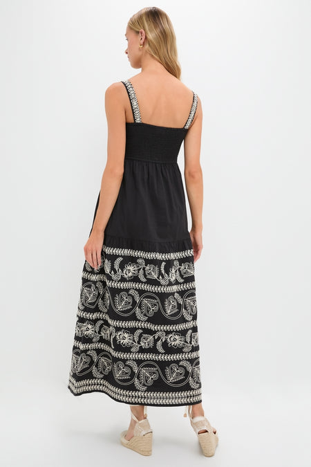 Model wearing the Sweetheart Rio Dress, a classic black maxi with white paisley embroidery, paired with effortless espadrille wedges. High-end, fun, and ready for any occasion.