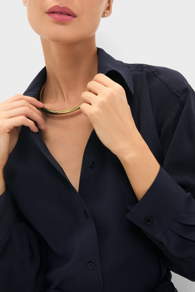 Person wearing the Midnight Alessandra Sarong Shirt Dress, showcasing a classic, effortless style with a fun, high-end appeal, accentuated by a sleek gold collar necklace.