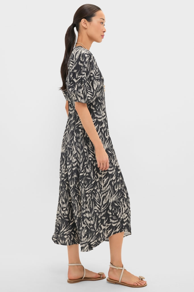 Woman modeling the classic Abstract Animal Midnight Bettina Maxi, featuring an effortless midi-length, elbow-length sleeves, and a flared skirt, styled with fun, high-end simplicity.