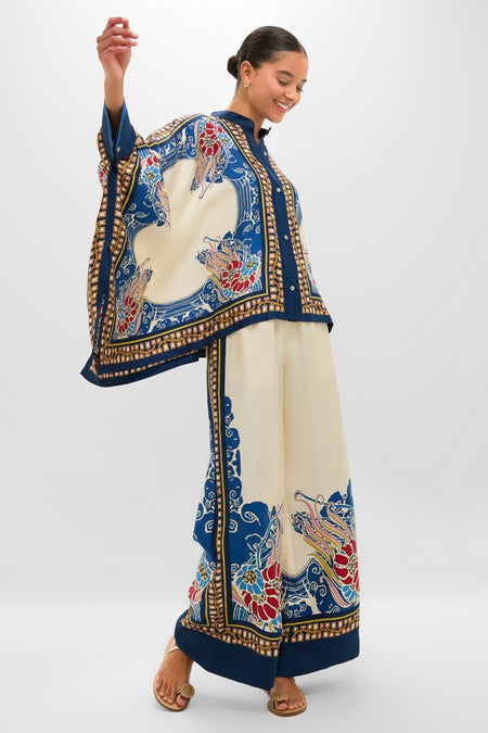 Woman models Lemuria Placee Palazzo Pants in a chic, classic print; effortlessly styled with matching shirt, showcasing high-end, fun, and relaxed fit trousers.