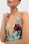 Zooflora One Piece Swimsuit: A classic halter-neck swimsuit in a deep-V style, featuring an effortless tropical print, perfect for a fun and high-end summer look.