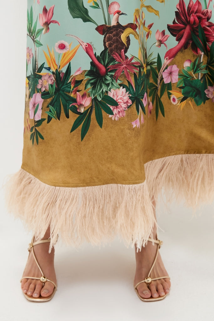Zooflora Panel Swing Dress with Feathers features a classic, effortless midi-length silhouette with a vibrant botanical print and fun feather trim, paired with high-end gold-toned strappy sandals.