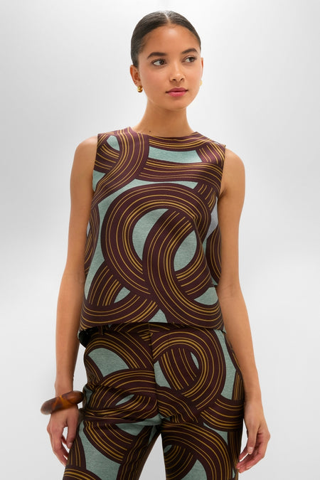 Young woman models the Montecarlo Jacquard La Scala Top with an effortless trapeze silhouette, featuring a longer back hem, embodying classic and fun high-end fashion.