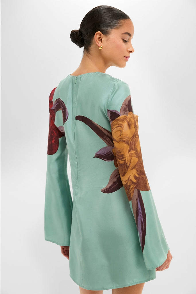 Woman models the Peony Placee Mini Supremes Swing Dress, featuring classic bell sleeves and an effortless A-line silhouette, perfect for a fun, high-end celebration.