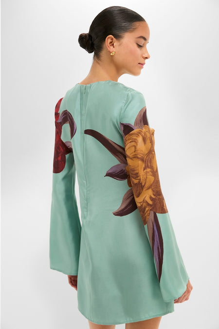 Woman models the Peony Placee Mini Supremes Swing Dress, featuring classic bell sleeves and an effortless A-line silhouette, perfect for a fun, high-end celebration.