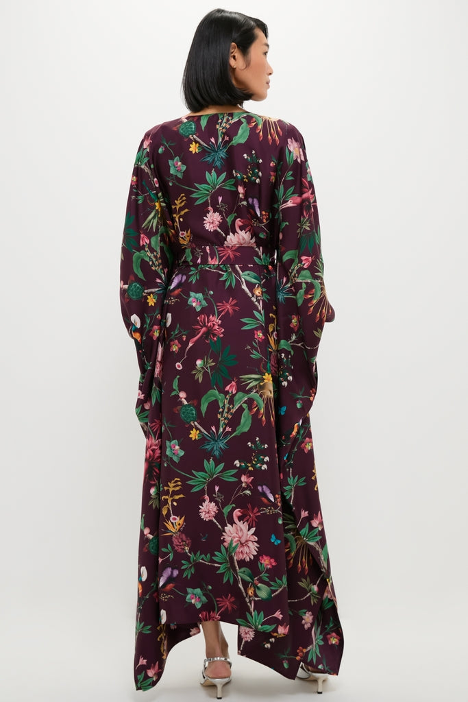 Woman in an effortless, high-end Zooflora Square Kaftan, featuring a classic kimono-style with wide sleeves, a floral print, and a removable sash belt.
