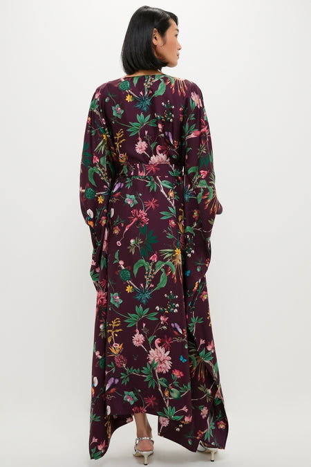 Woman in an effortless, high-end Zooflora Square Kaftan, featuring a classic kimono-style with wide sleeves, a floral print, and a removable sash belt.