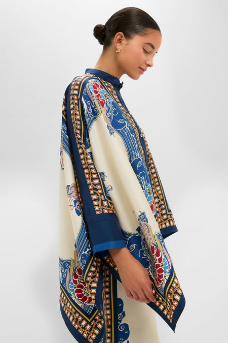 Young woman in profile wearing the Lemuria Placee Foulard Shirt, a classic, high-end, silk garment with effortless, fluid draping and intricate scarf-print design, embodying fun elegance.