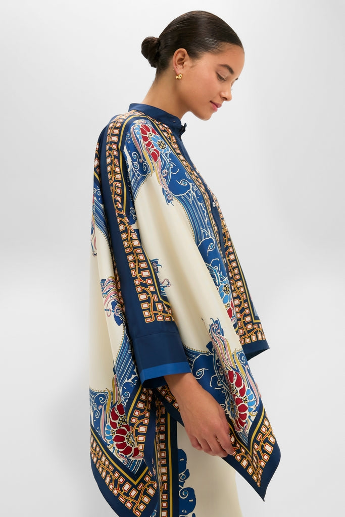 Young woman in profile wearing the Lemuria Placee Foulard Shirt, a classic, high-end, silk garment with effortless, fluid draping and intricate scarf-print design, embodying fun elegance.