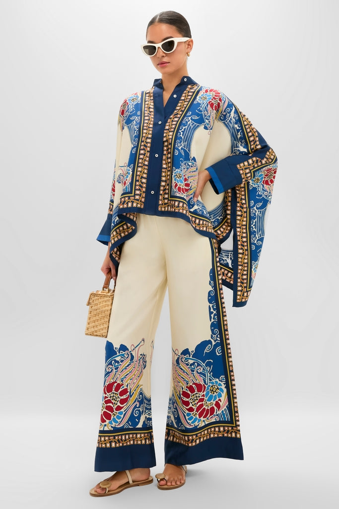 Model wearing the Lemuria Placee Foulard Shirt, an effortless, high-end silk top with a classic drape and bold print, styled with matching wide-leg pants and chic accessories.