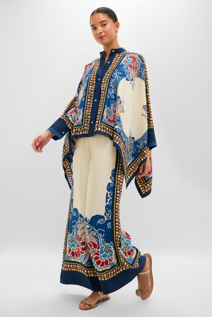 Model wears the Lemuria Placee Foulard Shirt, an effortless, high-end silk piece with a classic, cape-like drape, styled with matching wide-leg trousers for a fun, chic look.