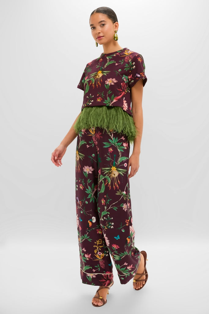 Model wearing classic Zooflora Pajama Pants in silk, featuring effortless wide-leg cut and elastic waist, styled with matching crop top for a fun, high-end resort look.