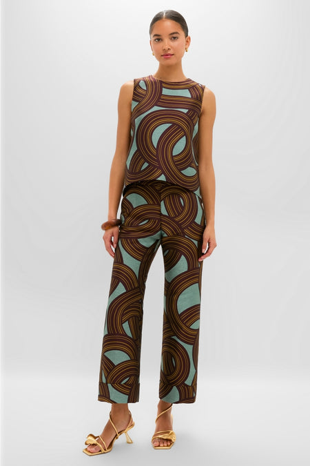 Woman models the Montecarlo Jacquard Hendrix Pants, featuring a classic high-waisted fit, effortless cropped length, and fun swirl pattern, paired with matching top and gold accessories.