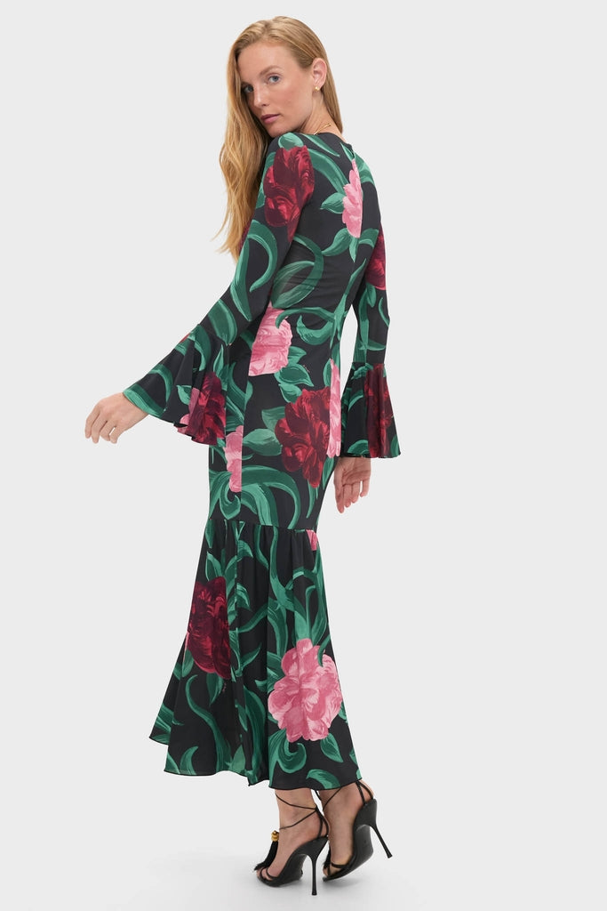 Woman in Peony Alba Dress with bell sleeves and flared skirt, exuding classic elegance and effortless style, perfect for a fun, high-end look.