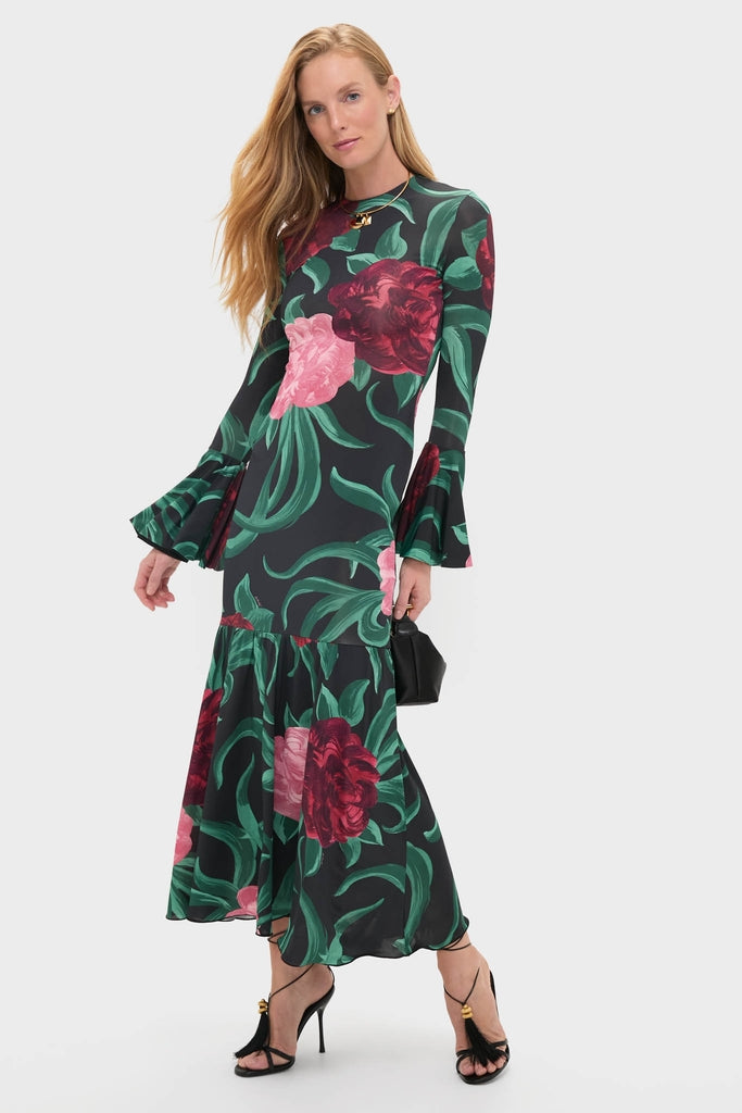Peony Alba Dress: A classic, high-end maxi featuring bold florals, tiered skirt, and flared sleeves. Paired with a black handbag and strappy heels for an effortless, fun look.