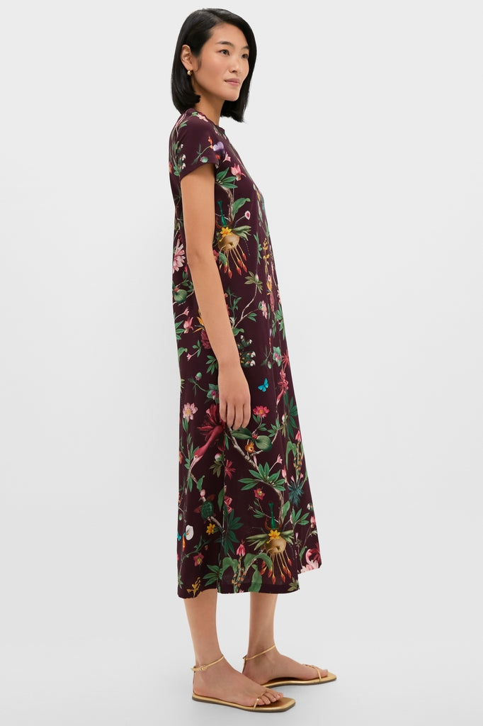 Woman in profile wears classic Zooflora Sporty Swing Dress, showcasing a fun, effortless botanical print, contrast rib collar, and side pockets, embodying high-end casual elegance.