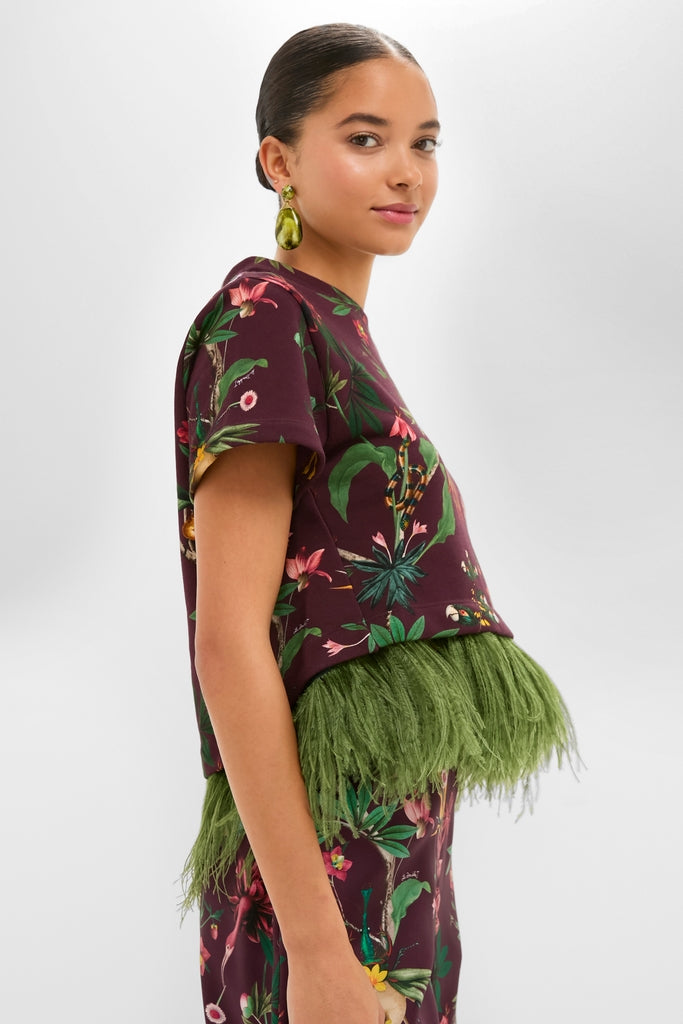 Zooflora La Scala Tee with Feathers: A high-end, classic cropped burgundy top with tropical patterns and a feather hem, exuding an effortless, fun style.