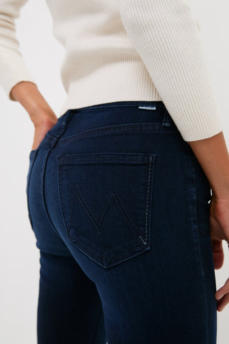 Close-up of someone wearing the Karaoke in Kyoto The Mid Rise Smokin Skimp jeans, showcasing a classic, effortless style with a subtle M detail on the pocket.