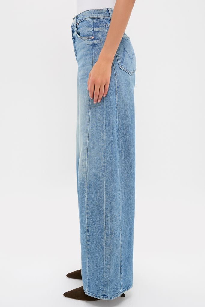 Folk Star The Pipe-Dream Button Sneak jeans showcase a classic, effortless style with high-waisted, wide-leg design, visible stitching, and belt loops, paired with pointed-toe brown shoes.