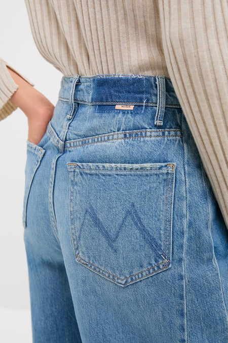 Folk Star The Pipe-Dream Button Sneak jeans showcase a classic, high-waisted fit with an effortless style, featuring a MOTHER tab, embodying fun and high-end design.