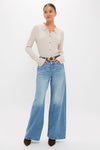Model wearing the classic Folk Star The Pipe-Dream Button Sneak, an effortlessly chic rib-knit top with wide-leg jeans and high-end accessories for a fun, sophisticated look.