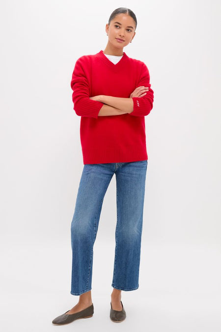 Person wearing Tambourine Man The Mid Rise Rambler Zip Ankle, showcasing classic, effortless style with fun, high-end appeal. Paired with a red sweater and flat shoes.