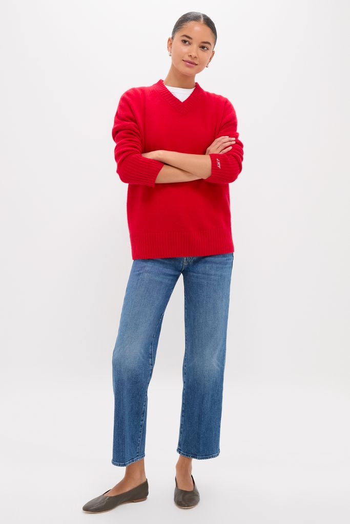 Person wearing Tambourine Man The Mid Rise Rambler Zip Ankle, showcasing classic, effortless style with fun, high-end appeal. Paired with a red sweater and flat shoes.