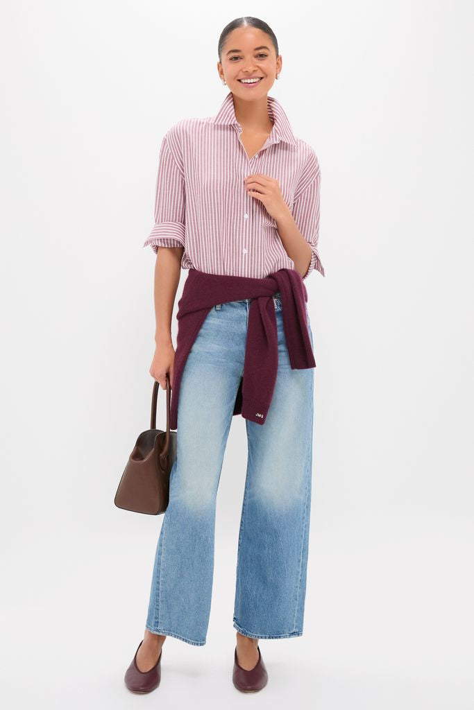 Young woman models Folk Star The Dodger Flood, featuring classic wide-leg jeans and an effortless striped shirt, with a fun burgundy sweater and high-end accessories.