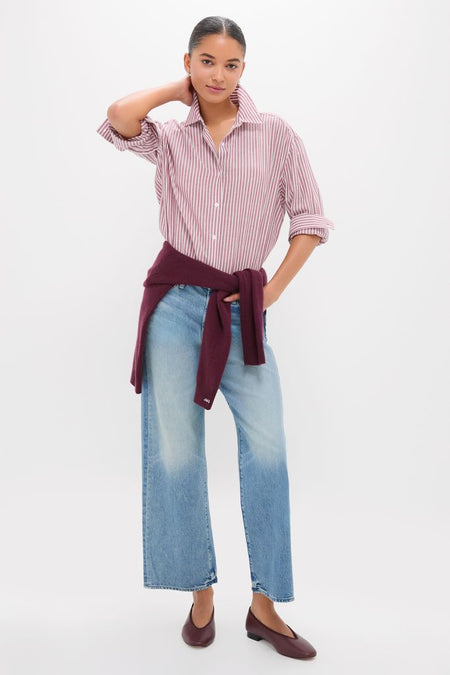 Model showcasing the Folk Star The Dodger Flood: a classic, effortless ensemble with a striped shirt, burgundy sweater, wide-leg jeans, and high-end ballet flats.