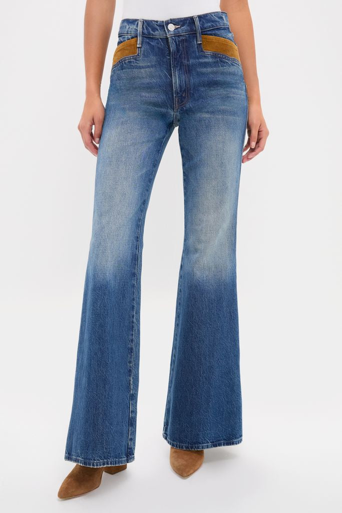 Classic high-waisted flare jeans with contrasting brown pocket trim and pointed-toe suede ankle boots, embodying an effortless, fun high-end style.