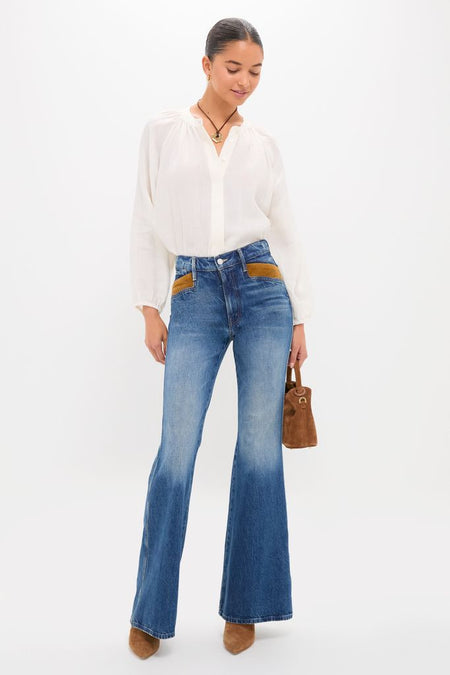 Woman models the Remember When The Pointy Pocket Doozy Heel, showcasing classic, effortless style with flared jeans and suede accents, epitomizing high-end, fun fashion.