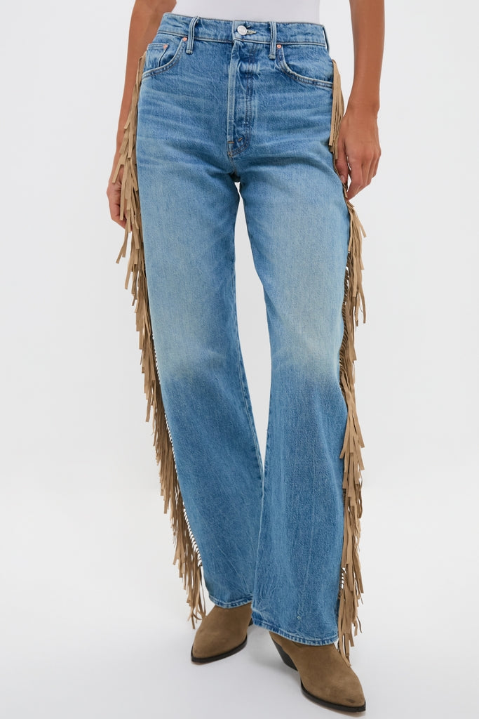 Folk Star The Fringe Half-Pipe Button Sneak: Classic high-waisted denim with playful tan fringe, effortlessly paired with high-end taupe suede boots, embodying fun and effortless style.
