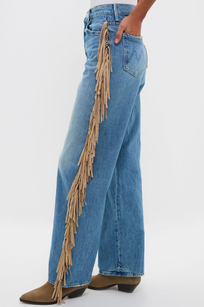Folk Star The Fringe Half-Pipe Button Sneak jeans feature classic wide-leg denim with effortless tan-suede fringe detailing, paired with fun and high-end brown suede boots.