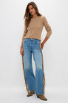 Model in Folk Star The Fringe Half-Pipe Button Sneak, showcasing classic, effortless style with a cable-knit sweater, wide-leg jeans, and suede ankle boots.