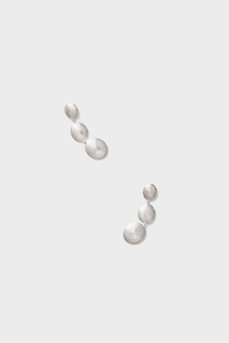 Silver Ruby Earrings: Classic drop earrings featuring three spiral-patterned discs in a silver-tone finish, exuding an effortless, fun, and high-end charm. Perfect for any chic ensemble.