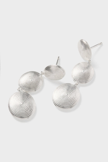 Silver Ruby Earrings: Classic and effortless silver-tone drop earrings with a fun spiral-ridge texture, featuring three linked discs for a high-end, whimsical statement look.