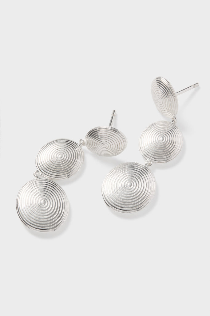 Silver Ruby Earrings: Classic and effortless silver-tone drop earrings with a fun spiral-ridge texture, featuring three linked discs for a high-end, whimsical statement look.