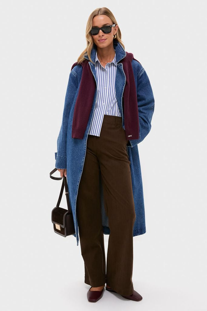 Gold Andrea Earrings add a classic, high-end touch to this model's effortless style, featuring a denim coat and burgundy accents against a light-gray background.